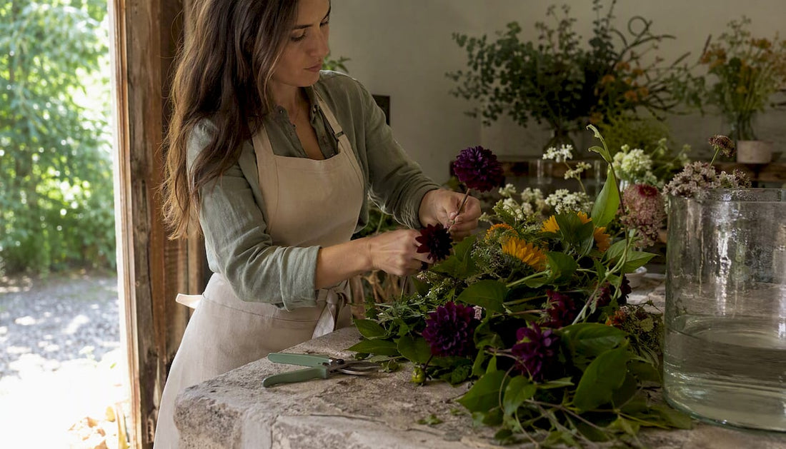 Floral designer arranging curated bouquet indoors